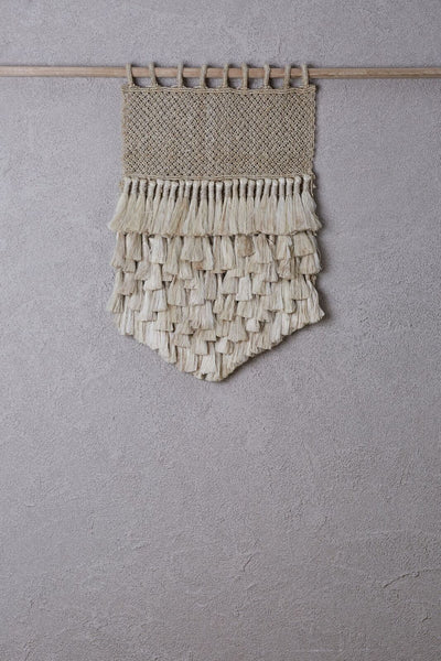 small jute wall hanging on bamboo hanging rod 